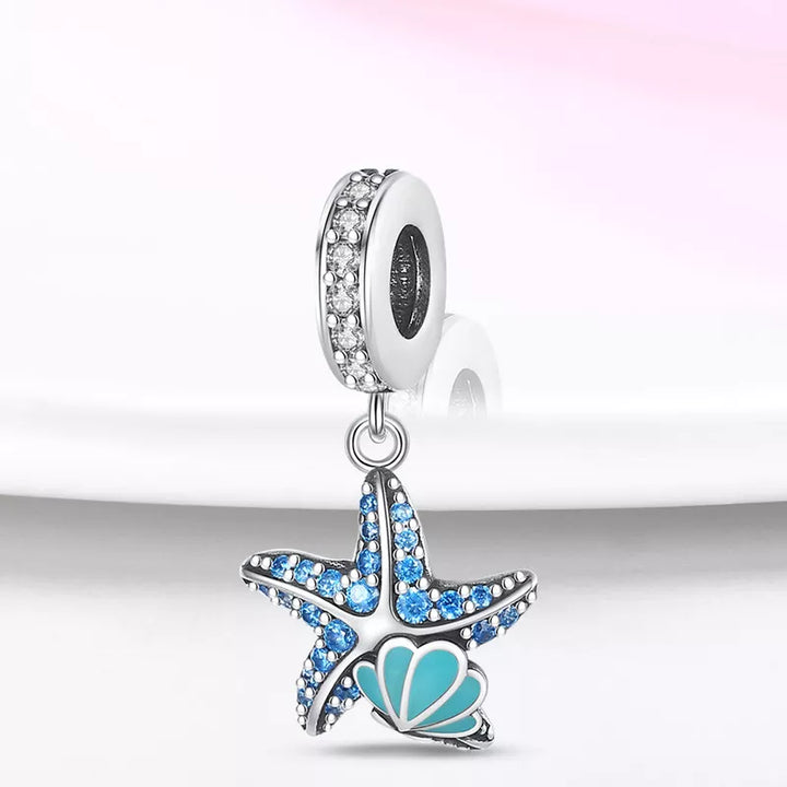 Charm Estrella de Mar y Concha Fluorescentes