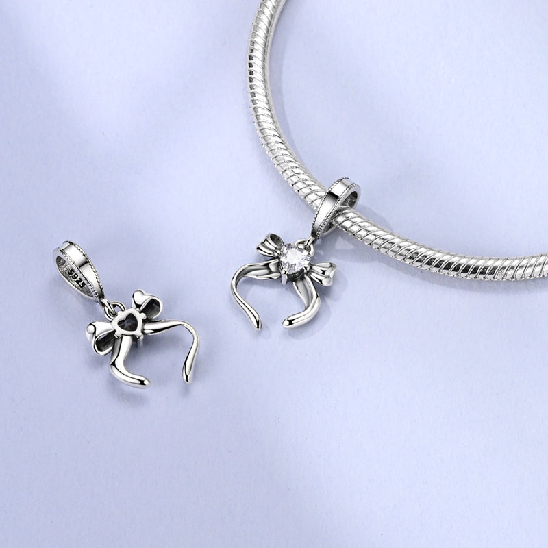 Charm Moño Plateado